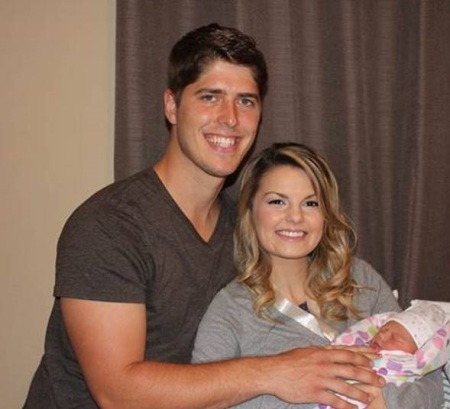 Alyssa Bates and husband John Webster hold daughter Allie Jane.