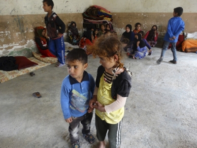 Refugees displaced from Albu Faraj sit in a classroom of a school used as a shelter for displaced people in the city of Ramadi, Iraq, April 11, 2015.