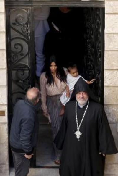 Kim Kardashian carries daughter North West who was baptized in Jerusalem on April 13, 2015.