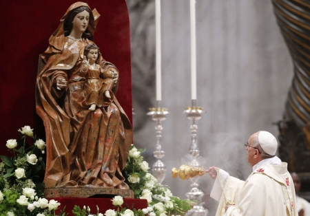 Pope Francis I swings an incense burner to bless a statue of the Virgin Mary, Vatican, May 11, 2014.