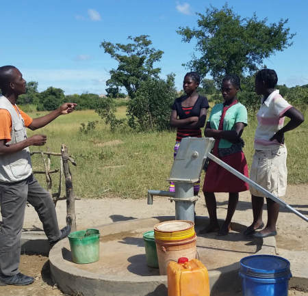 World Vision Zambia Communications Officer Collins Kaumba speaks with school girls on March 24, 2015, at a village in Bulanda in Hamaundu, Zambia.