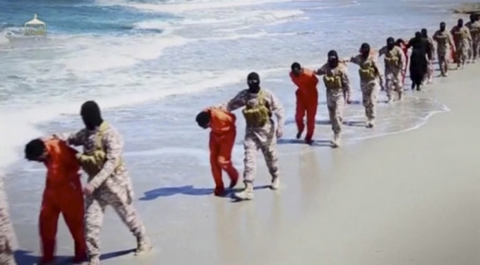 Islamic State militants lead what are said to be Ethiopian Christians along a beach in Wilayat Barqa, in this still image from an undated video made available on a social media website on April 19, 2015. The video purportedly made by Islamic State and posted on social media sites on Sunday appeared to show militants shooting and beheading about 30 Ethiopian Christians in Libya. Reuters was not able to verify the authenticity of the video but the killings resemble past violence carried out by Islamic State, an ultra-hardline group which has expanded its reach from strongholds in Iraq and Syria to conflict-ridden Libya. Libyan officials were not immediately available for comment. Ethiopia said it had not been able to verify whether the people shown in the video were its citizens.