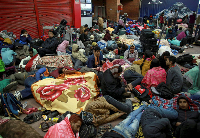 People wait outside the departure terminal at the airport in Kathmandu, Nepal, April 27, 2015, following the April 25 earthquake.