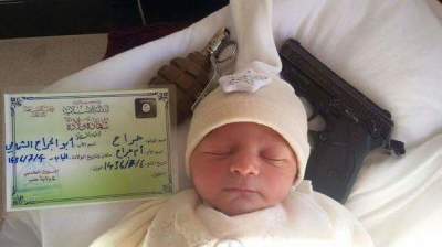 Image of a newborn baby pictured next to a handgun, grenade and Islamic State birth certificate released in April, 2015.