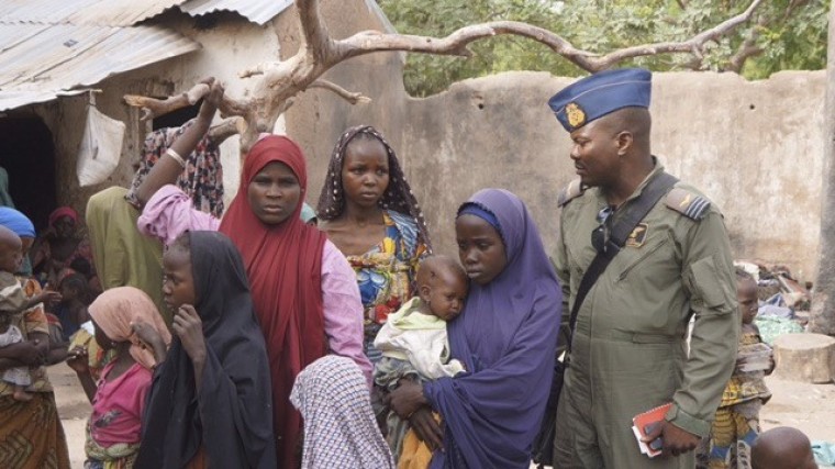 A soldier from the Nigerian Army talks with hostage women and children who were freed from Boko Haram, in Yola, in this April 29, 2015, handout. Nigeria's military rescued another set of women and children who had been kidnapped by Boko Haram militia and were being detained in Sambisa forest where the Islamist group has been holed up, an army spokesman said on April 30.