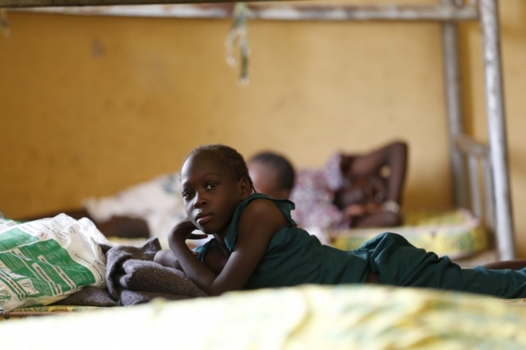 A child rescued by the Nigerian army from Boko Haram militants in the Sambisa forest rests on a bed at the Malkohi camp for internally displaced people in Yola, Nigeria, May 3, 2015. Picture taken May 3, 2015.