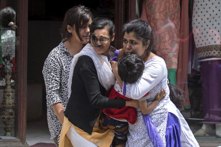 Local residents evacuate from a shop during an earthquake in central Kathmandu, Nepal, May 12, 2015. At least three people were killed and more than 300 injured in Nepal after a magnitude 7.3 earthquake shook the Himalayan nation on Tuesday, police said. The latest casualties came just weeks after a devastating quake, with a magnitude of 7.8, killed more than 8,000 people in Nepal and damaged hundreds of thousands of buildings.