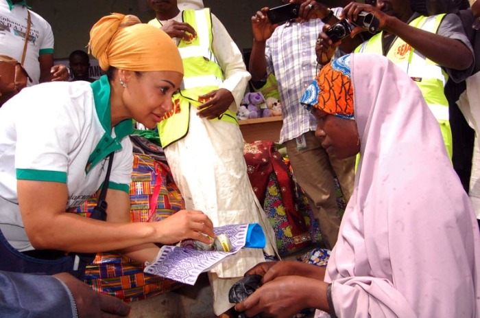 A beneficiary receiving items needed to start her own business making traditional caps in Gombe State, Nigeria.