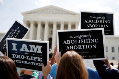 Anti-abortion protestors celebrate the U.S. Supreme Court's ruling striking down a Massachusetts law that mandated a protective buffer zone around abortion clinics, outside the Court in Washington, June 26, 2014.