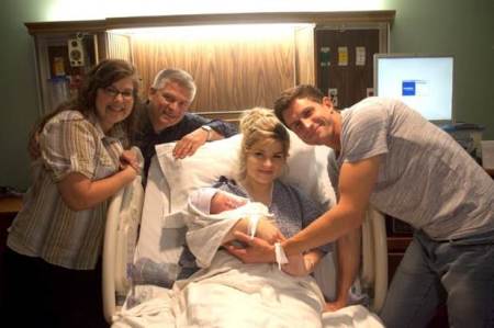 Erin and Chad Paine, along with son Carson and Erin's parents, Gil and Kelly Jo Bates.