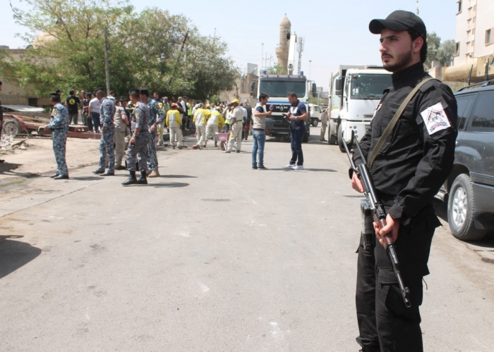 An Iraqi Christian fighter, a member of Babylon Christian Battalion, stands guard near the site of car bomb attack in Baghdad, May 5, 2015.