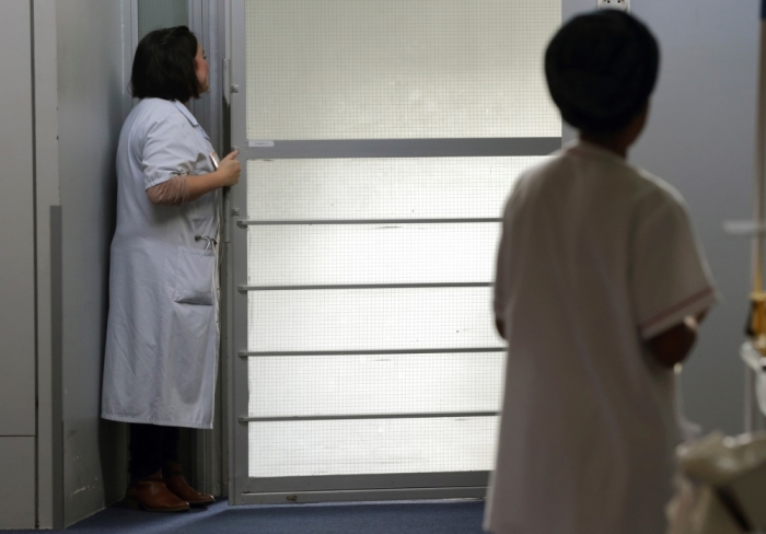 Nurses work at the palliative care unit of the AP-HP Paul-Brousse Hospital in Villejuif near Paris, March 4, 2015. France's parliament will on Tuesday debate a bill allowing patients near the end of their lives to stop treatment and enter a 'deep sleep' until they die, a move that critics say amounts to euthanasia in disguise. If passed, the legislation would give dying patients in the secular but majority Catholic country more power over their own treatment. Jean Leonetti, a centre-right lawmaker and doctor who authored the law, told Reuters the bill would allow patients with 'hours or days to live' to request to be placed under general anaesthetic right through to the moment they die.