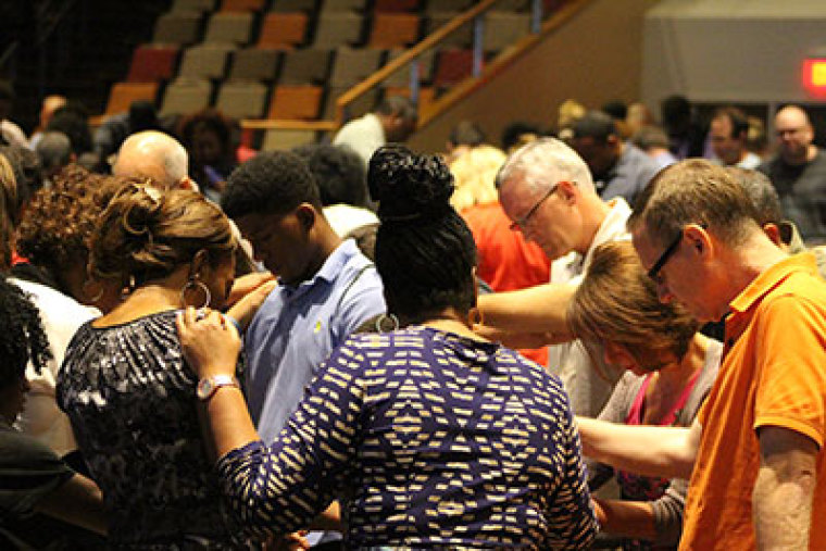 Local pastors in McKinney, Texas, meet with Mayor Brian Loughmiller and Police Chief Greg Conley Monday night, June 8, 2015, to discuss and pray over an altercation between police, local residents and teenagers at a private pool for residents in the Craig Ranch neighborhood of McKinney, located north of Dallas.