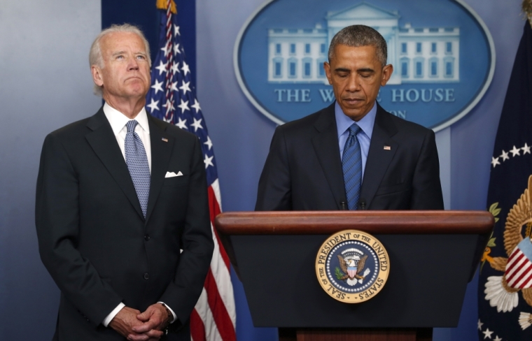 U.S. President Barack Obama (R) delivers remarks in reaction to the shooting deaths of nine people at an African-American church in Charleston, South Carolina, from the podium in the press briefing room of the White House in Washington June 18, 2015. Vice President Joe Biden listens at left.