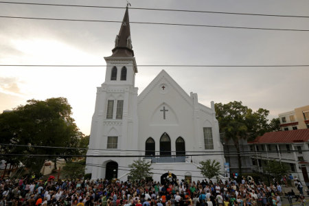 A crowd gathers outside the Emanuel African Methodist Episcopal Church following a prayer vigil nearby in Charleston, South Carolina, June 19, 2015, two days after a mass shooting left nine dead during a bible study at the church.