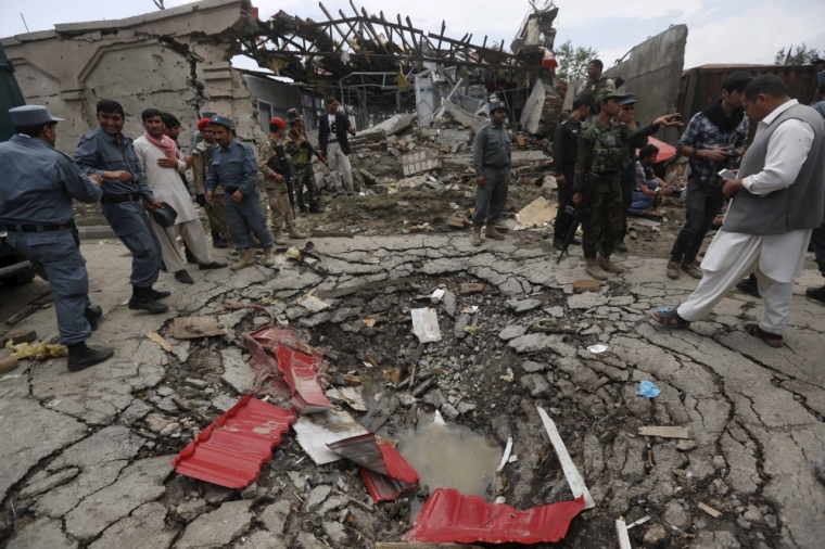 Members of Afghan security forces stand at the site of an attack near the Afghan parliament in Kabul, Afghanistan, June 22, 2015. A Taliban suicide bomber and six gunmen attacked the Afghan parliament on Monday, wounding at least 19 people and sending a plume of black smoke across Kabul, as a second district in two days fell to the Islamist group in the north.