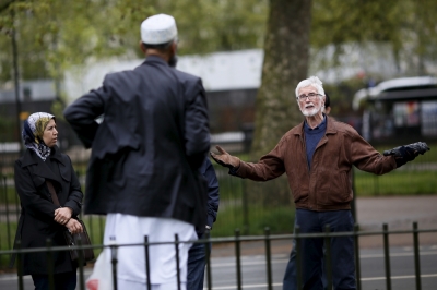 A man gestures during a speech by Muslim speaker Osman (C) at Speakers' Corner in Hyde Park, London, Britain May 3, 2015.