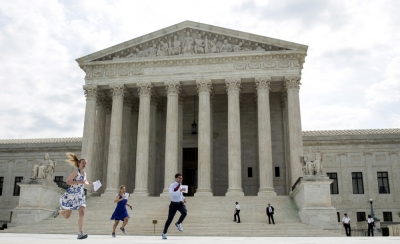 Interns with media organizations run with the decision upholding the Affordable Care Act at the Supreme Court in Washington June 25, 2015. The U.S. Supreme Court on Thursday upheld the nationwide availability of tax subsidies that are crucial to the implementation of President Barack Obama's signature healthcare law, handing a major victory to the president.