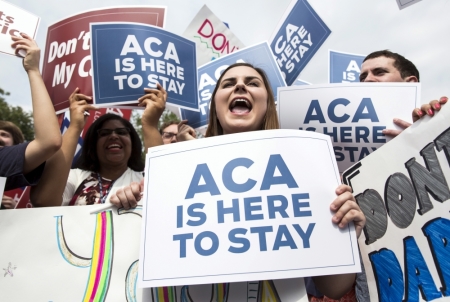 Supporters of the Affordable Care Act celebrate after the Supreme Court up held the law in the 6-3 vote at the Supreme Court in Washington June 25, 2015. The U.S. Supreme Court on Thursday upheld the nationwide availability of tax subsidies that are crucial to the implementation of President Barack Obama's signature healthcare law, handing a major victory to the president.