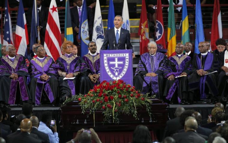 President Barack Obama speaks behind the coffin of the Rev. Clementa Pinckney during funeral services for Pinckney in Charleston South Carolina June 26, 2015.