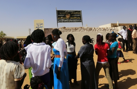 South Sudanese Christians living in the North gather to attend Christmas day celebrations at a Catholic church in the Umbada locality of Omdurman, December 25, 2013.