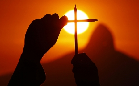 A demonstrator holds pencils in tribute to the victims of a shooting by gunmen at the offices of French satirical weekly Charlie Hebdo, during a demonstration organized by the NGO Rio de Paz (Rio of Peace) in Niteroi, near Rio de Janeiro, January 8, 2015. 