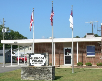 The Glencoe Police Department in Alabama pictured here with the Christian flag (R) before it was removed in late June 2015 after the Freedom From Religion Foundation sent a letter to the city threatening a lawsuit if the religious symbol remained on public property.