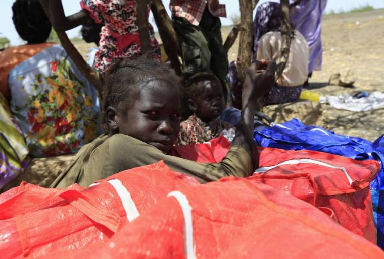 South Sudanese fleeing an attack on the town of Rank rest upon arrival at a border gate in Joda, along the Sudanese border, on April 18, 2015.