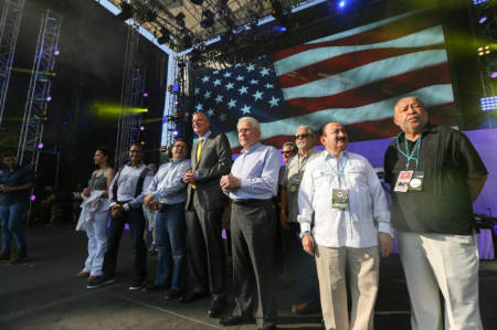 New York City Mayor Bill de Blasio stands on stage with several local pastors and evangelist Luis Palau at the Great Lawn at Central Park on July 11, 2015, in New York City.