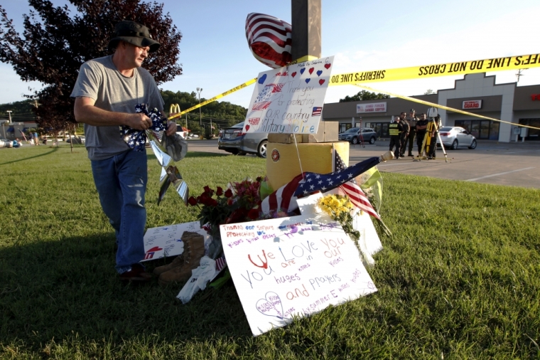 David Croft places items at a growing memorial in front of the Armed Forces Career Center in Chattanooga, Tennessee, July 16, 2015. Four Marines were killed on Thursday by a gunman who opened fire at two military offices in Chattanooga, Tennessee, before being fatally shot in an attack officials called a brazen, brutal act of domestic terrorism.