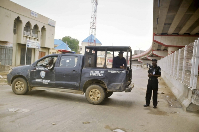 A security operative blocks a road leading to a prayer ground during Eid-al-Fitr prayers, marking the end of the holy month of Ramadan, at Sheikh Ahamdu Tijjani Mosque at Kofar Mata in Kano, Nigeria, July 17, 2015.