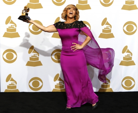 Erica Campbell holds the award for Best Gospel Album for 'Help' backstage during the awards pre-telecast at the 57th annual Grammy Awards in Los Angeles, California, February 8, 2015.