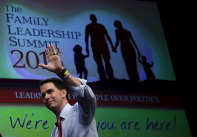 U.S. Republican presidential candidate Gov. Scott Walker waves as he leaves the Family Leadership Summit in Ames, Iowa, United States, July 18, 2015.