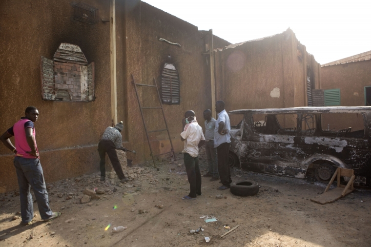 Men start reconstruction works on an evangelical church that was destroyed in riots demonstrating against French satirical magazine Charlie Hebdo's cartoons of the Islamic prophet Muhammad, in Niamey, Niger, January 23, 2015. At least five people were killed last Saturday in protests in Niger against Charlie Hebdo's cartoons of the Muslim prophet Muhammad, authorities said, bringing the death toll from two days of violence in the country to 10.