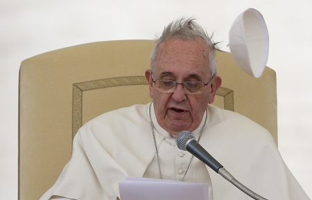 A gust of wind blows Pope Francis's skull cap off during his Wednesday general audience in Saint Peter's square at the Vatican, February 19, 2014.