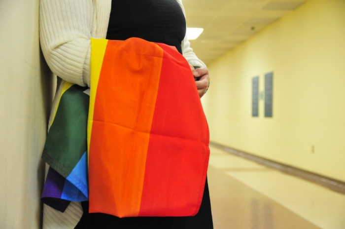 A supporter stands waits to congratulate gay couples as they receive their marriage licenses at the Oklahoma County courthouse in Oklahoma City, Oklahoma, October 6, 2014.