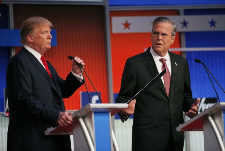 Republican 2016 presidential candidates, businessman Donald Trump (L) and former Florida Governor Jeb Bush, take their places at their podiums before the start of the first official Republican presidential candidates debate of the 2016 U.S. presidential campaign in Cleveland, Ohio, August 6, 2015.