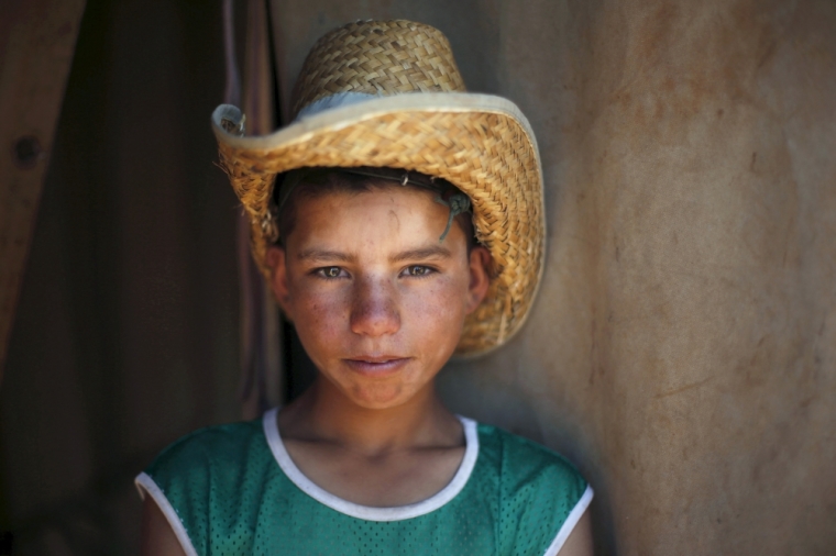 A Syrian refugee child, who has been living in Jordan with their family's since 2.5 years after fleeing the violence in their Syrian hometown of Idlib, poses in front of their family residence in Madaba city, near Amman, Jordan, July 9, 2015. The number of Syrian refugees in neighboring countries has passed 4 million, the U.N. refugee agency UNHCR said on Thursday, adding that the total was on course to reach 4.27 million by the end of 2015.