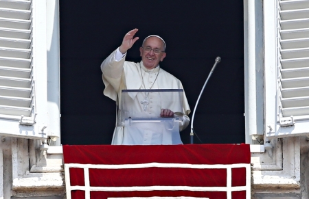 Pope Francis waves as he leads the Angelus prayer from the window of the Apostolic palace in Saint Peter's Square at the Vatican August 9, 2015.