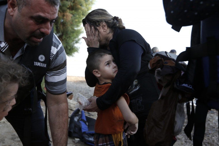 A Syrian boy is hugged by his mother moments after they arrived at a beach on the Greek island of Kos after crossing a part of the Aegean sea from Turkey to Greece, August 15, 2015. The United Nations refugee agency called on Greece to take control of the 'total chaos' on Mediterranean islands, where thousands of migrants have landed. About 124,000 have arrived this year by sea, many via Turkey, according to Vincent Cochetel, UNHCR director for Europe.