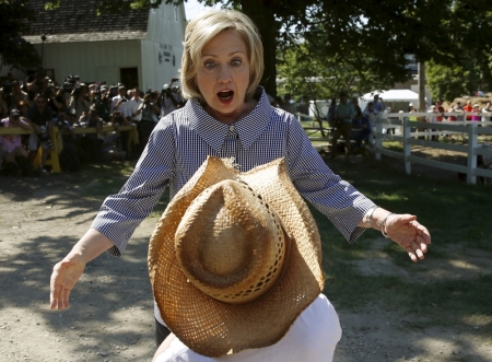 U.S. Democratic presidential candidate Hillary Clinton greets Louie Dixon as she campaigns at the Iowa State Fair in Des Moines, Iowa, United States, August 15, 2015.