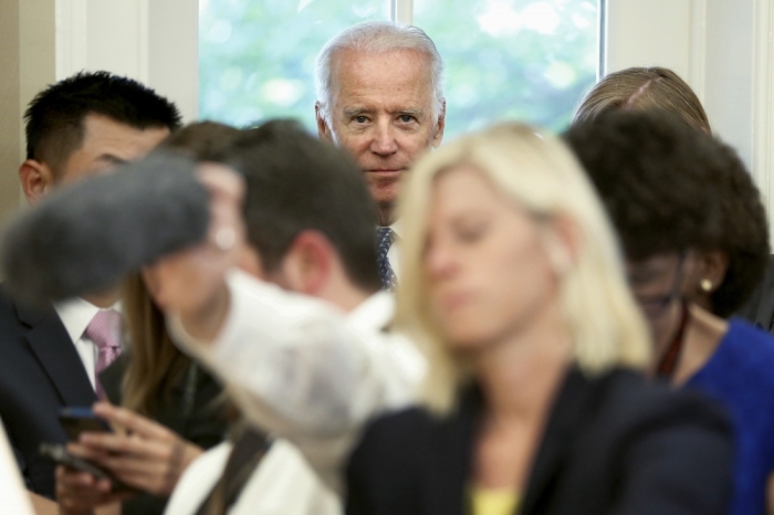 U.S. Vice President Joe Biden (C) stands behind reporters as President Barack Obama and U.N. Secretary-General Ban Ki-moon make statements after their meeting in the Oval Office at the White House in Washington, D.C., United States August 4, 2015.