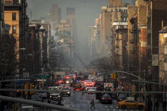 New York City Fire Department firefighters and emergency personnel respond at the site of a residential apartment building which had collapsed and was engulfed in flames in New York City's East Village neighborhood March 26, 2015. An apparent gas explosion caused two residential apartment buildings to collapse and burst into flames, and two others to catch fire, injuring 12 people on Thursday in New York City's East Village neighborhood, authorities said.