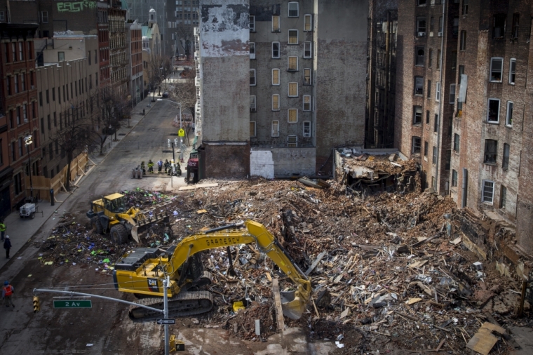 Crews remove debris at the site of a multi-building collapse on 2nd Avenue in New York, March 30, 2015.