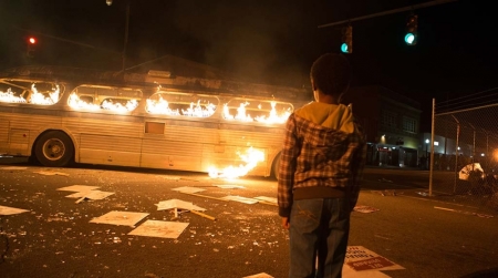 An image from the upcoming film 'Woodlawn' that depicts a bus burning during 1970s Alabama.