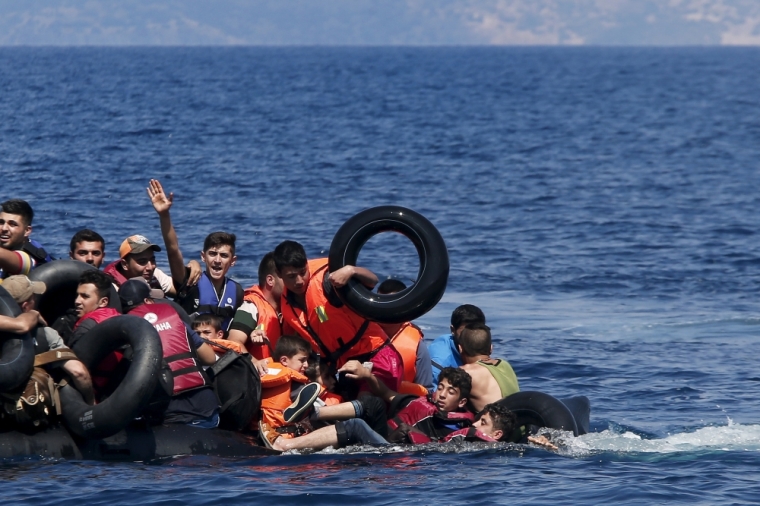 Syrian and Afghan refugees fall into the sea after their dinghy deflated some 100m away before reaching the Greek island of Lesbos, September 13, 2015. Of the record total of 432,761 refugees and migrants making the perilous journey across the Mediterranean to Europe so far this year, an estimated 309,000 people had arrived by sea in Greece, the International Organization for Migration said on Friday. About half of those crossing the Mediterranean are Syrians fleeing civil war, according to the United Nations refugee agency.