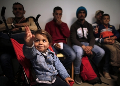 A young girl reacts moments after refugees from Syria and Irak arrived at a refugee centre in Champagne-sur-Seine, near Paris, France, September 9, 2015. France is ready to take in 24,000 refugees as part of European Union plans to welcome more than 100,000 in the next two years, the French President said on Monday, dismissing opinion polls showing public opposition to the move.