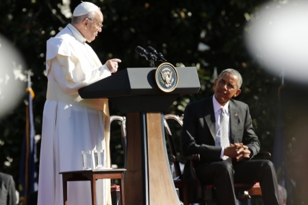 Pope Francis (L) speaks as U.S. President Barack Obama looks on as the pontiff is welcomed to the White House during a ceremony in Washington, September 23, 2015.