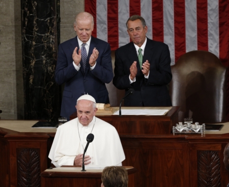 Speaker of the House John Boehner (R) and Vice President Joe Biden applaud as Pope Francis arrives to give his speech to the U.S. Congress in Washington, September 24 2015.