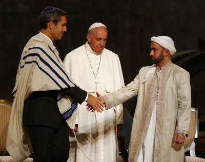 Rabbi Elliot Cosgrove and Imam Khalid Latif shake hands in front of Pope Francis.